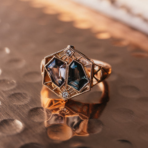 Two coffin shaped grey/blue spinels in a custom designed rose gold engagement ring