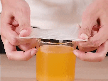 a hand holding a cup