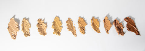 Color swatches of OUMERE foundation starting from the lightest in the left to deepest on the right.