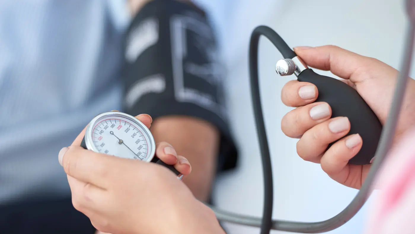 person having blood pressure checked with machine