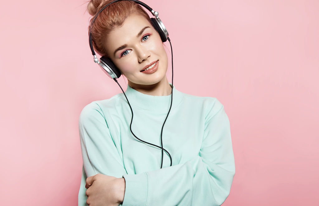 happy woman listening to music on headphones