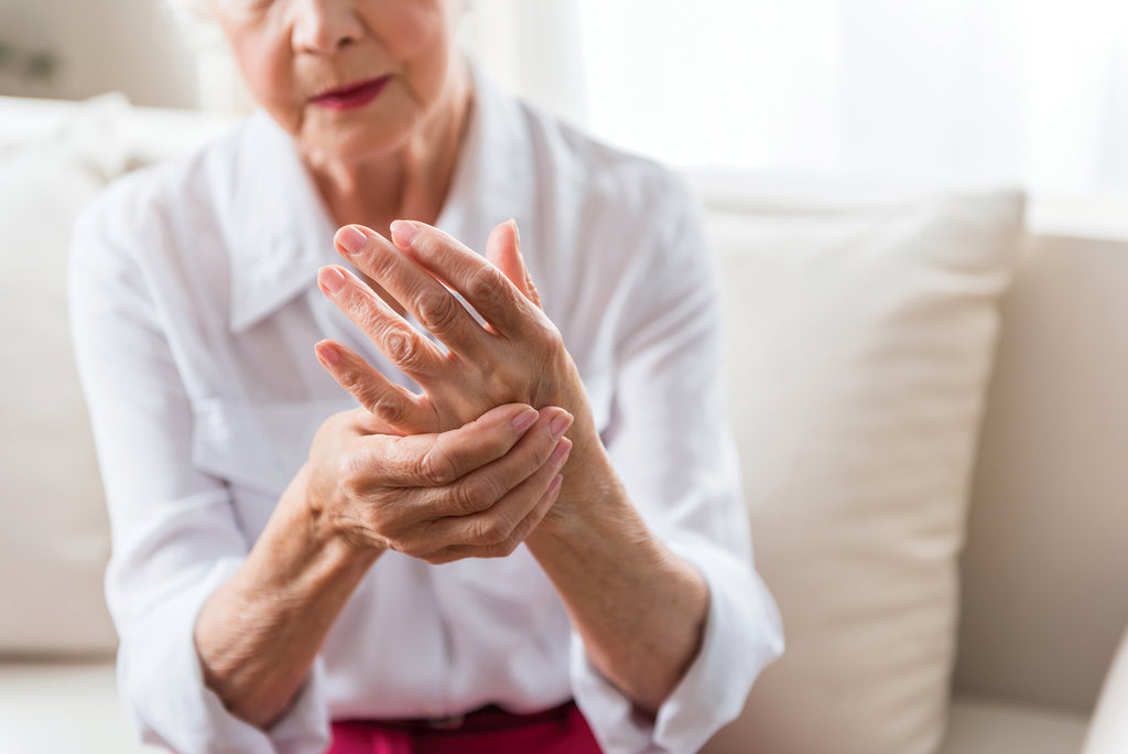 older woman rubbing her hands