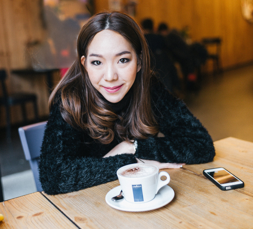 young girl sitting at table smiling