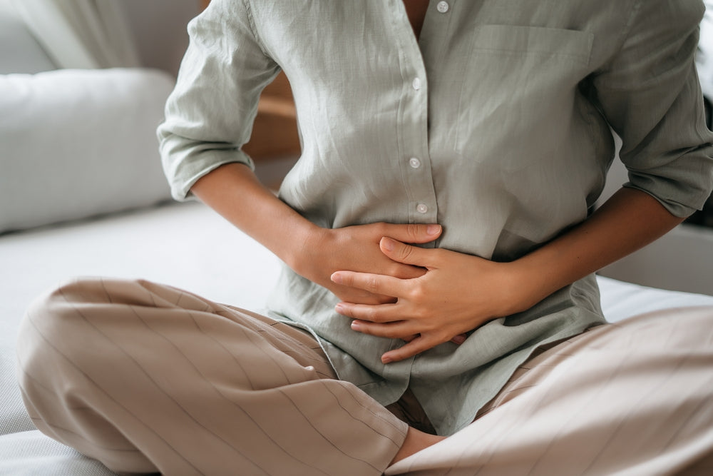 Woman holding stomach, stomach pain