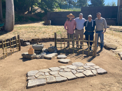 John and his group with their finished stone arrangement