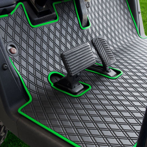 a golf cart with a fitted floor mat with green trim