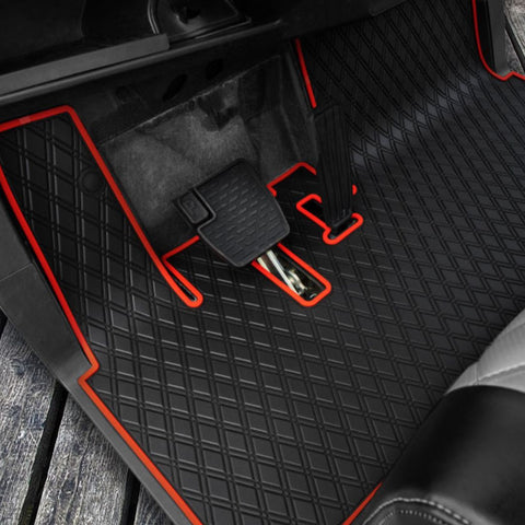 a golf cart with a fitted floor mat with red trim