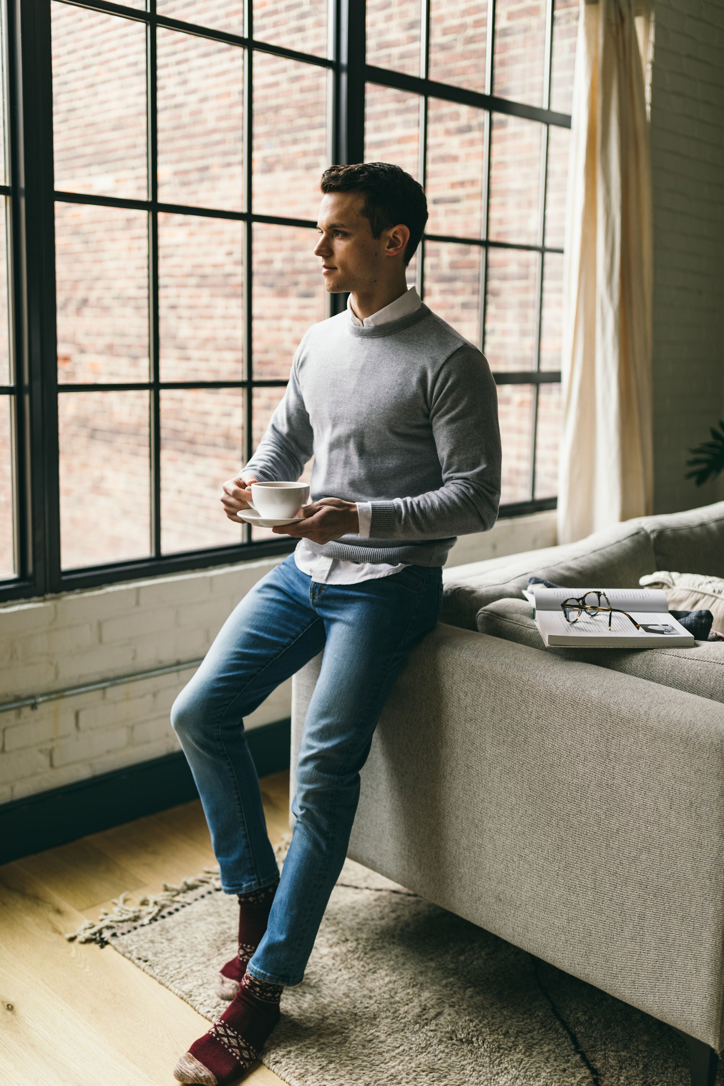 Grey sweater over white button up shirt