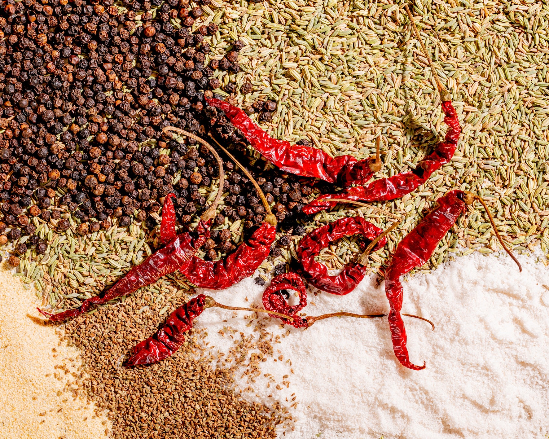 All the whole and ground spices in the Steak Masala with a scattering of whole red chillies on top 