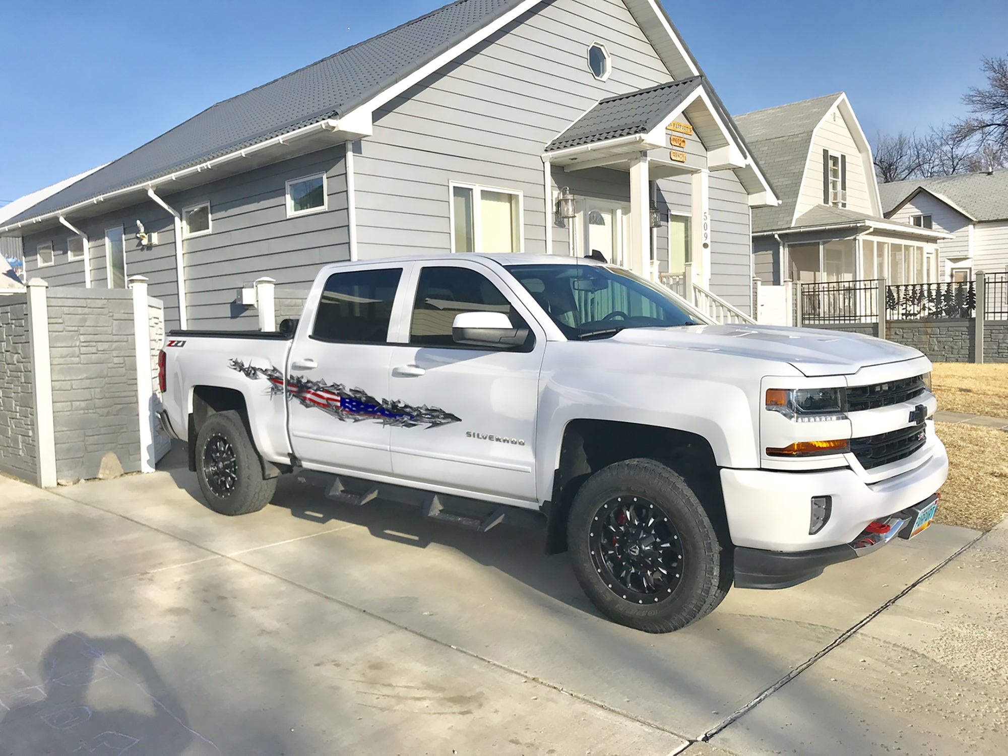 American flag tear on white silverado truck