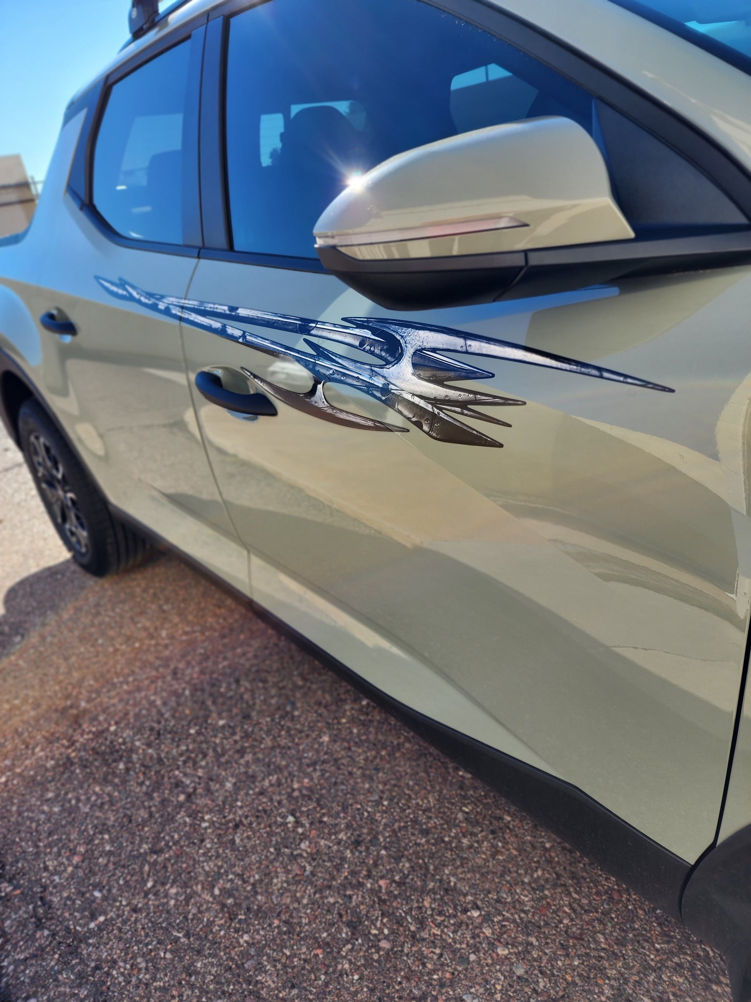 Tribal edge silver vinyl graphics on the side of hyundai pickup 