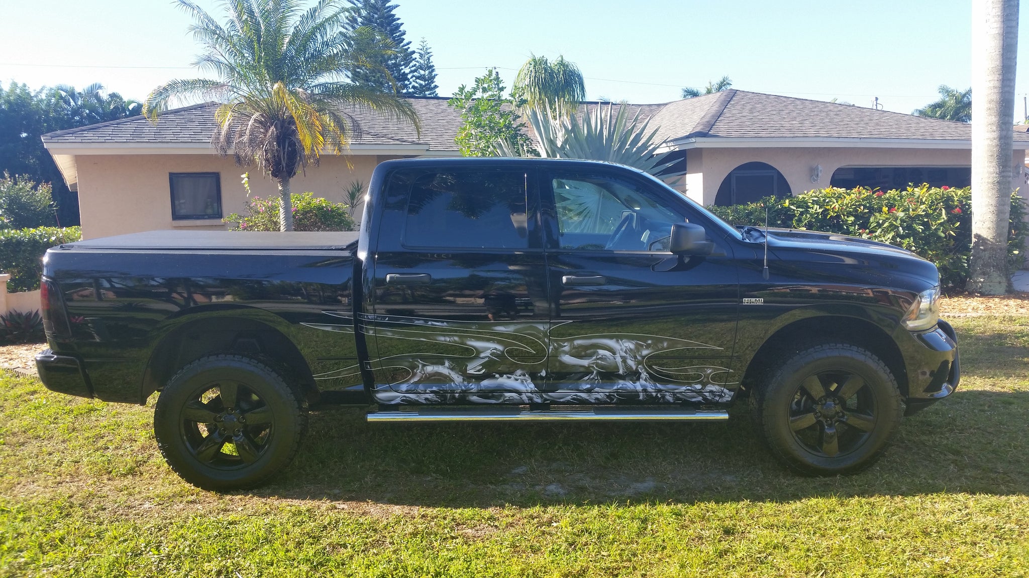 dragons vinyl wrap on side of black dodge truck