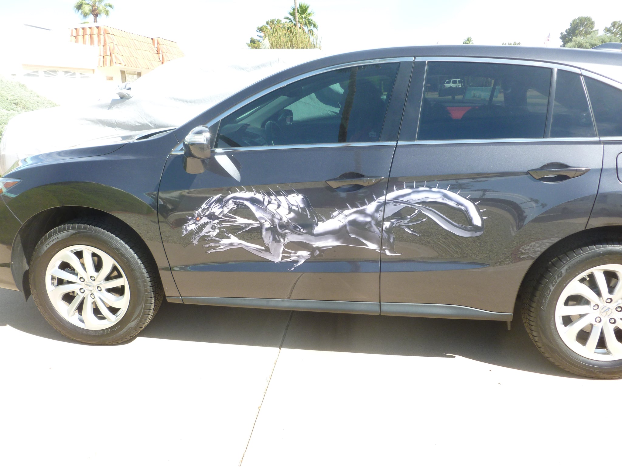 metal dragon graphic decal on accura suv