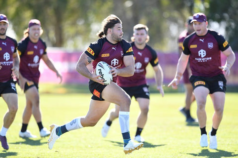 Queensland maroons training on the field. with some wearing Bauerfeind sports compression products