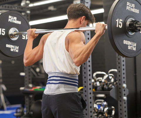 Man weightlifting at the gym in Bauerfeind's LumboTrain Back Brace