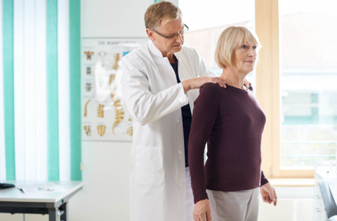 Doctor assessing patient for osteoporosis