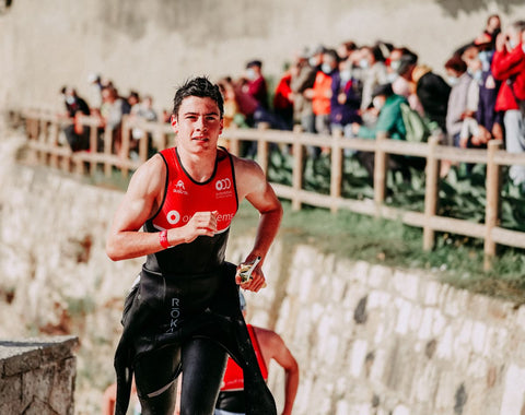 Triathlete leaving the beach to start the cycle portion of the race. He opted to get half-out of his triathlon suit