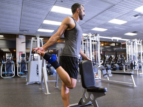 Man exercising in gym wearing Bauerfeind ankle brace