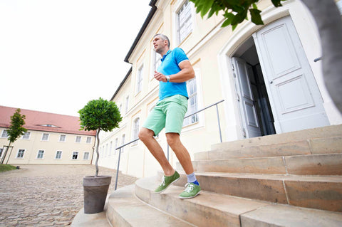Man walking down steps wearing Bauerfeind ankle brace