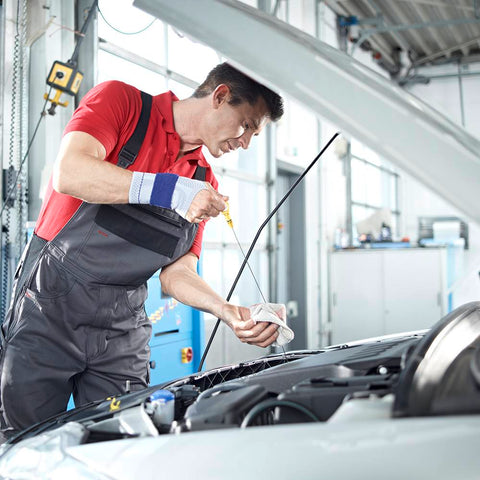 Man wearing wrist brace while working on a car
