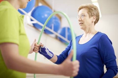 Person holding a hula hoop doing thumb exercises