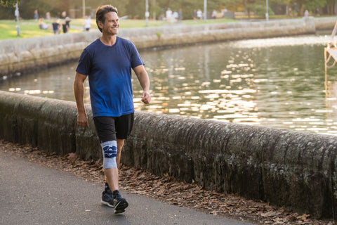 Man walking in a GenuTrain Knee Brace