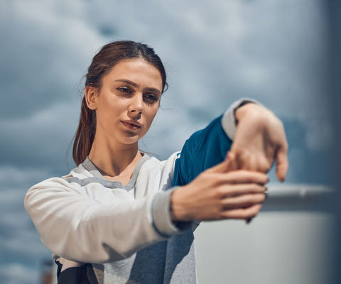 Woman stretching her wrist before gardening