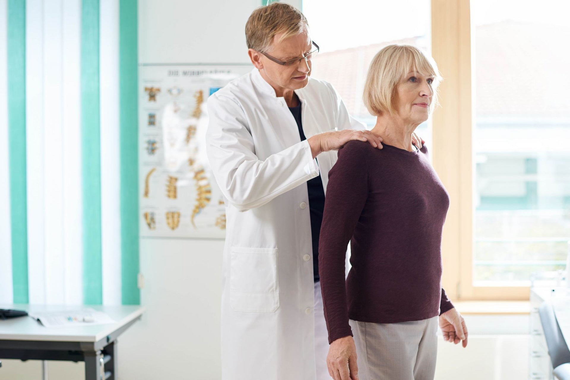 Doctor assessing patient for osteoporosis