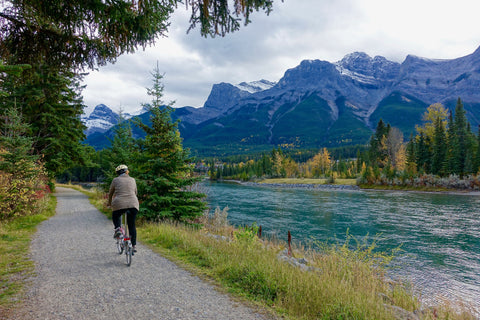 Person returning to cycling after injury. They're riding through a park along a flat path with plenty of room