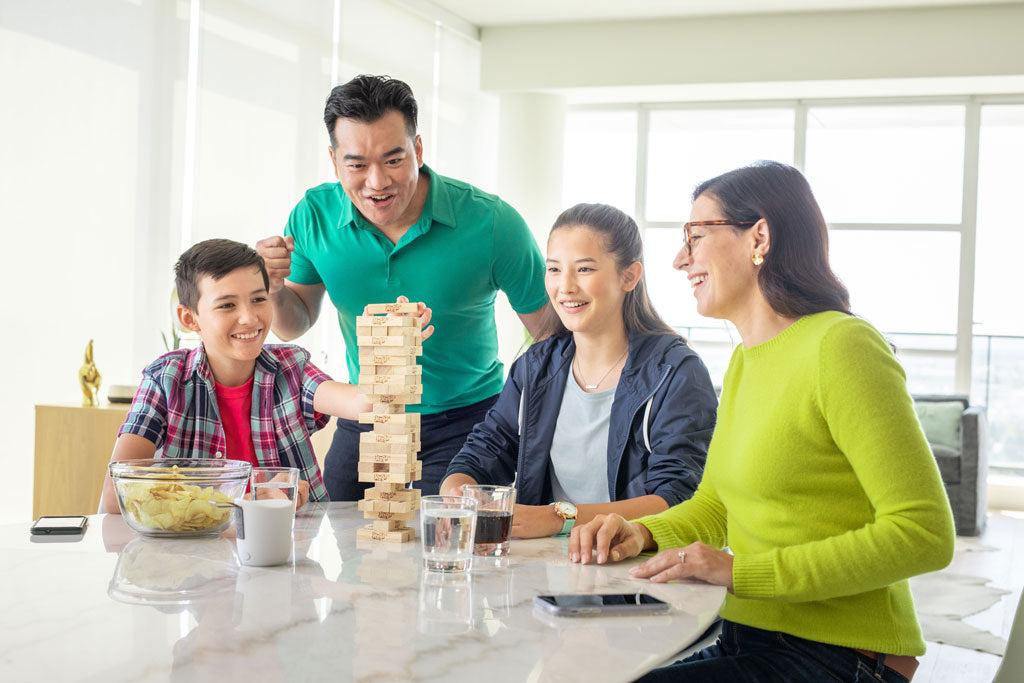 Family playing games at ktichen table