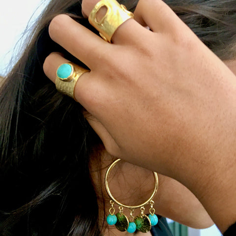 gold colored thick band made of brass with hammered design and turquoise round circular stone set in the middle of this adjustable sized ring that is made in turkey. Turqoise bohemian jewlery , turkish rings bohemian rings  exotic jewlery goldrings gold rings with stones . imported 