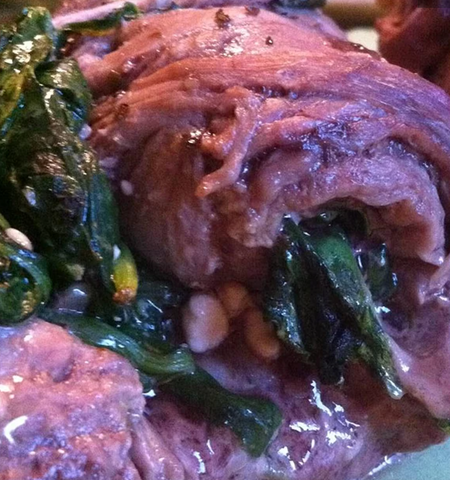 Image of raw bison being rolled with the ingredients.