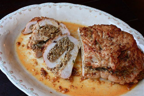 Image of plated and sliced boudin-stuffed turkey roulade.