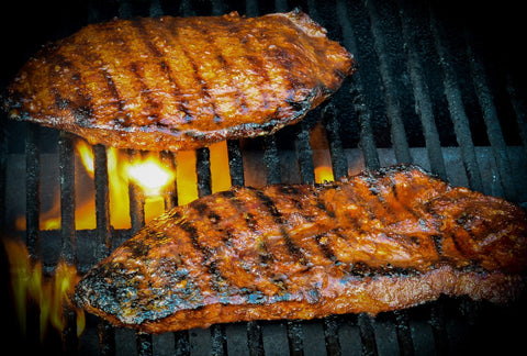 Photo of the2 pieces of flat iron steak on the grill.