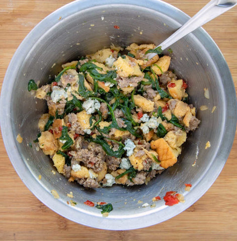 Image of the stuffing mixture compile and in a large mixing bowl.