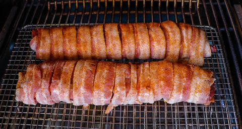 Image of two backstraps cooking on the smoker.