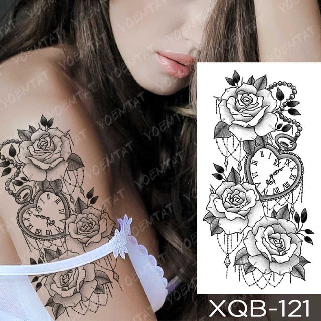 Lace black rose tattoo on the right inner forearm