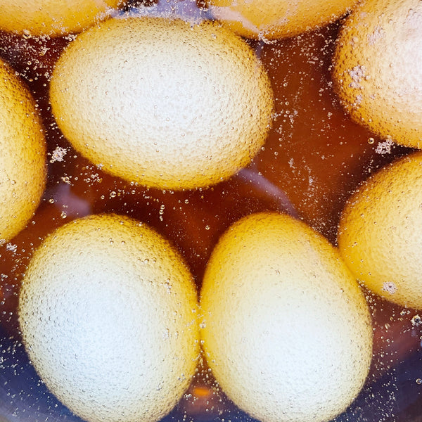 hard boiled eggs soaking in apple cider vinegar