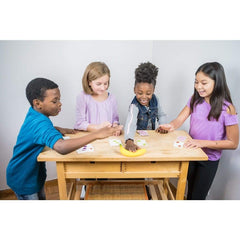 four children of different ethnicities around a wooden, child size table, playing Fruit Punch card game