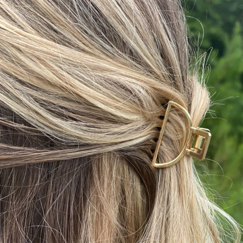 closeup of gold clip in hair