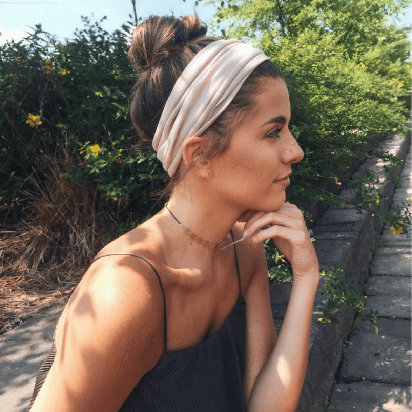 high bun with tan headband