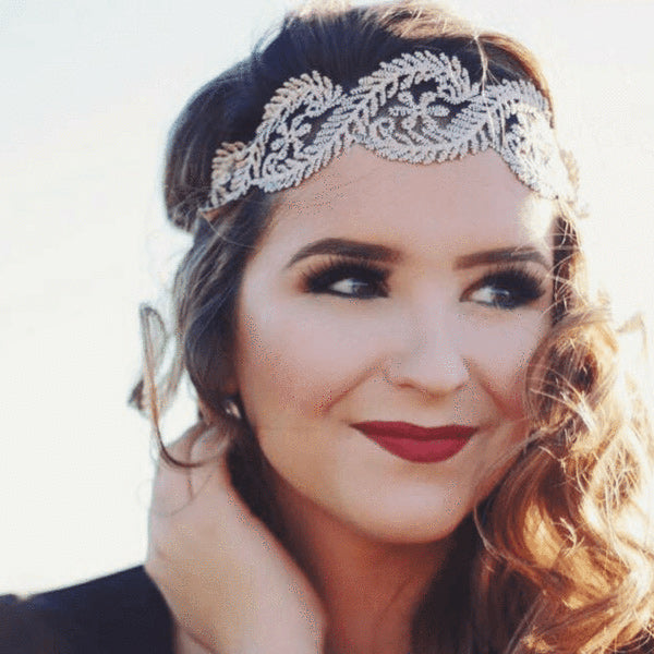 a woman wearing a lace forehead headband