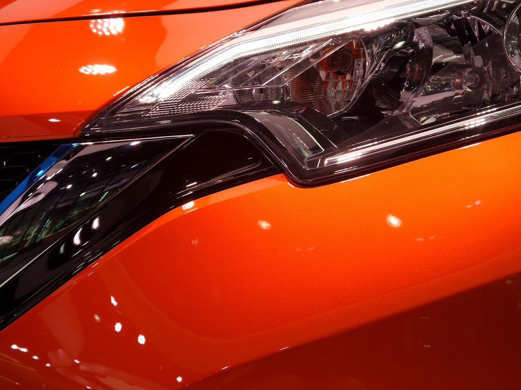 Orange Nissan Maxima Front Bumper and Headlight Closeup