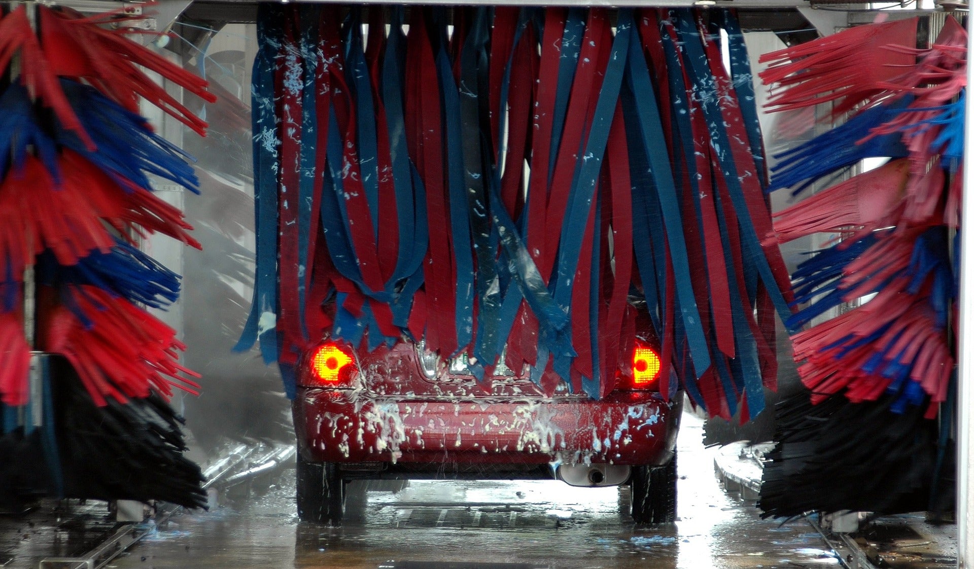 Car wash shot from back of car. Tails lights. Removing sap