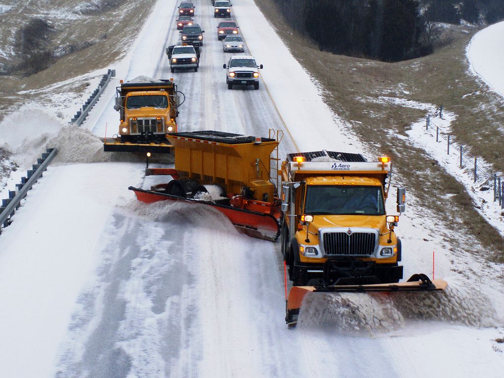 Snow plow clearing highway