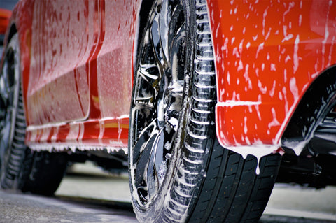 Soapy car being hand washed