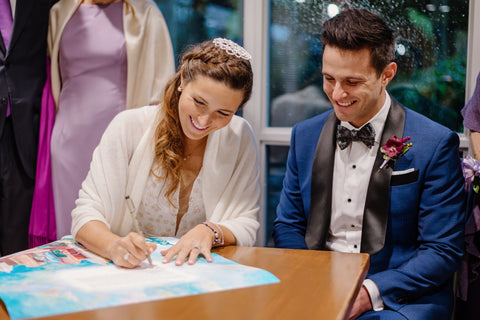 Sarah signing her ketubah