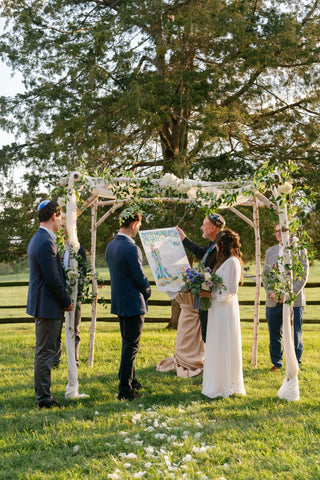 Mazel Tov! Sara and Jonah under the chuppah with hand painted ketubah by Anna Abramzon