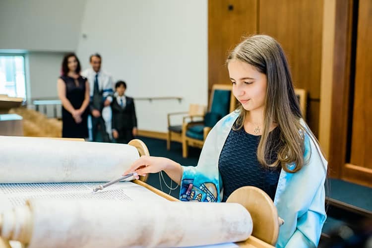 A Jewish girl wearing a tallit at her bat mitzvah