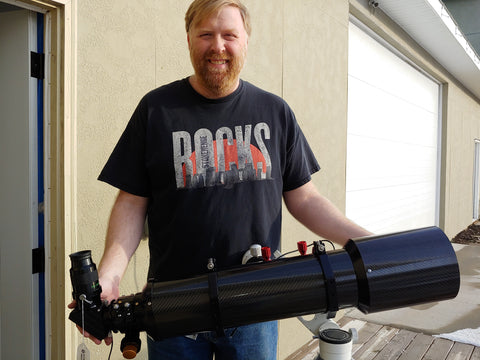 A Man Holding DayStar SolaREDi H-Alpha 127mm Dedicated Solar Telescope - Prominence